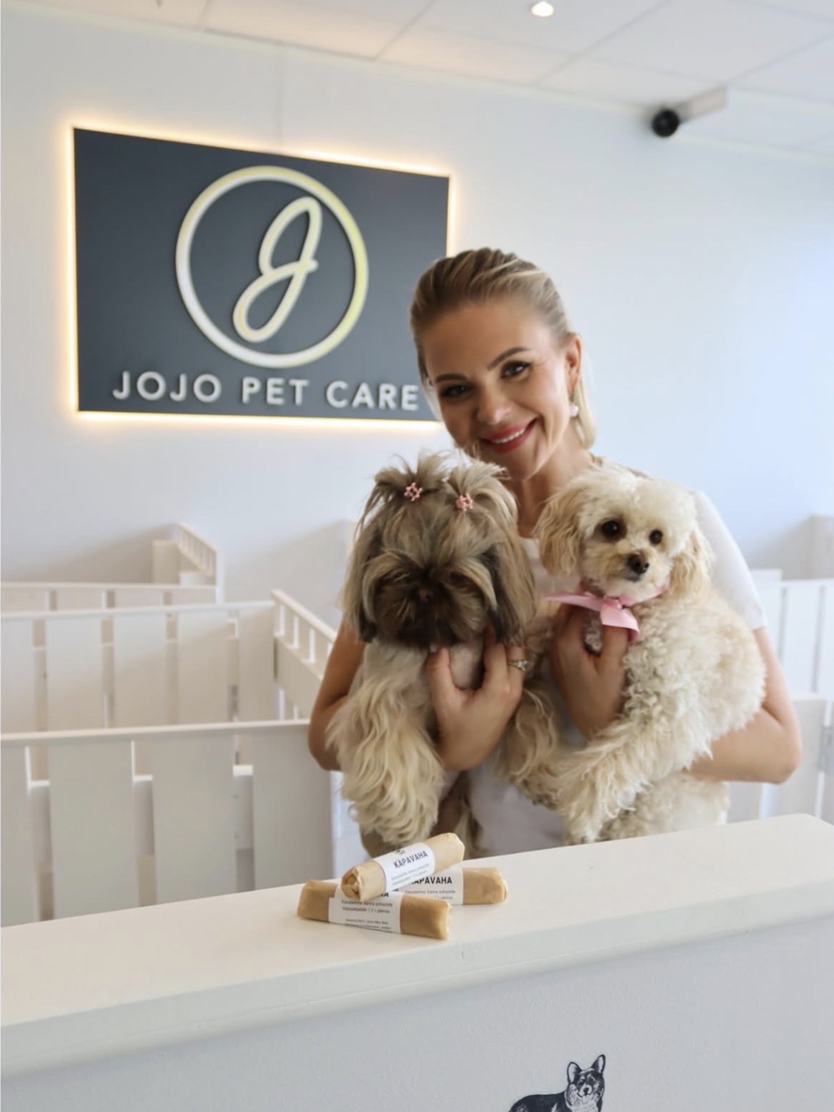 Eve at the JoJo Pet Care salon with two freshly groomed dogs